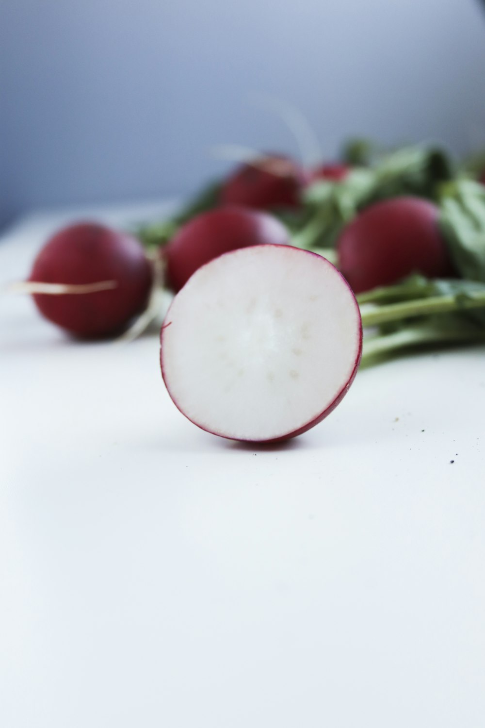 red tomato on white table