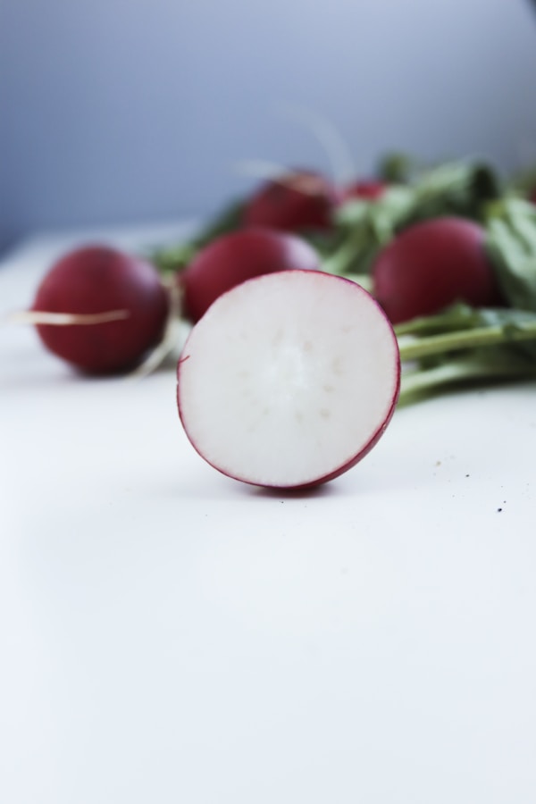 Red tomato on white table