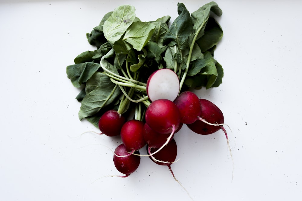 red tomatoes on white surface