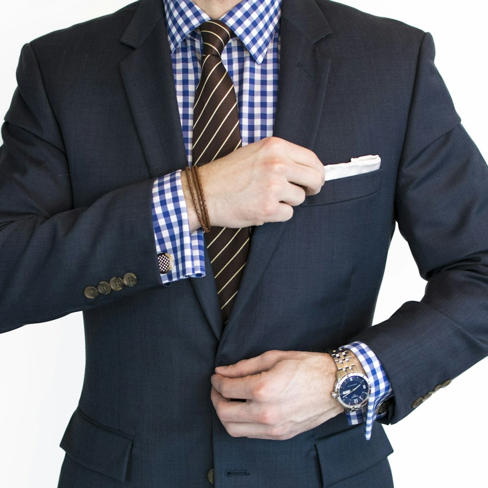 man in black suit jacket wearing gold watch