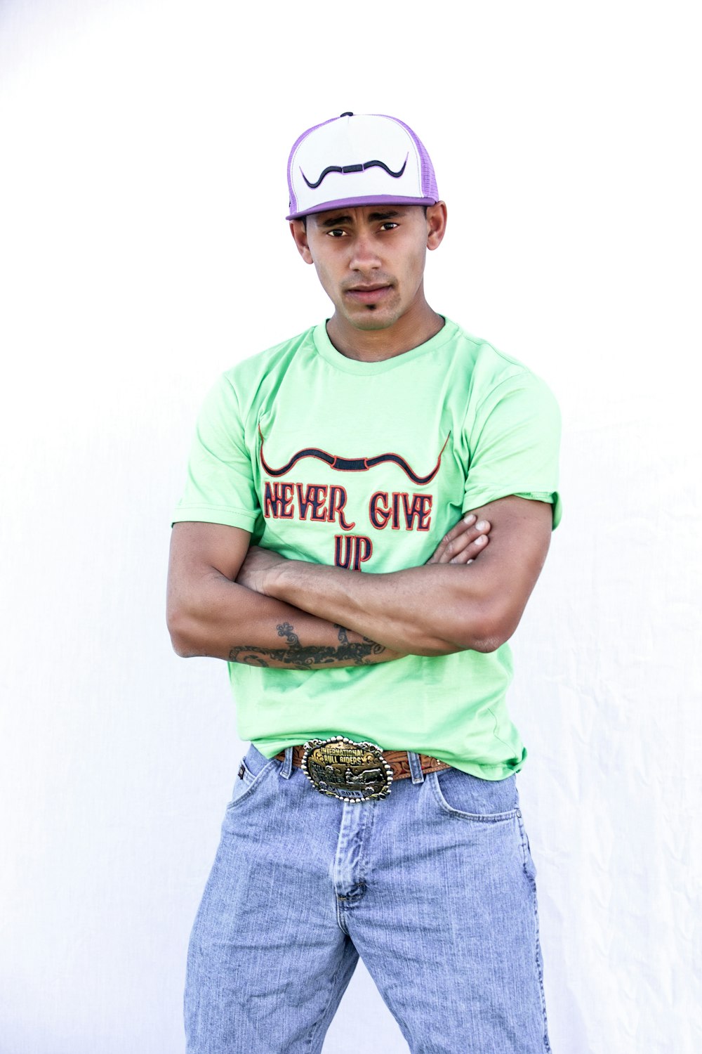 man in green crew neck t-shirt and blue denim shorts