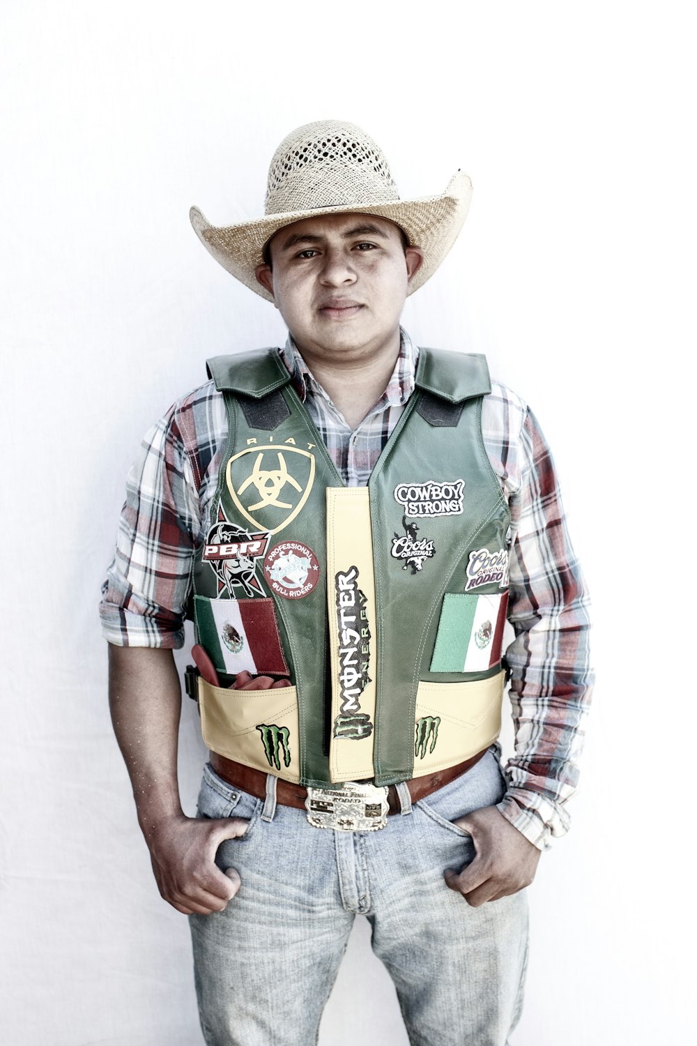 man in green white and red plaid button up shirt wearing brown cowboy hat