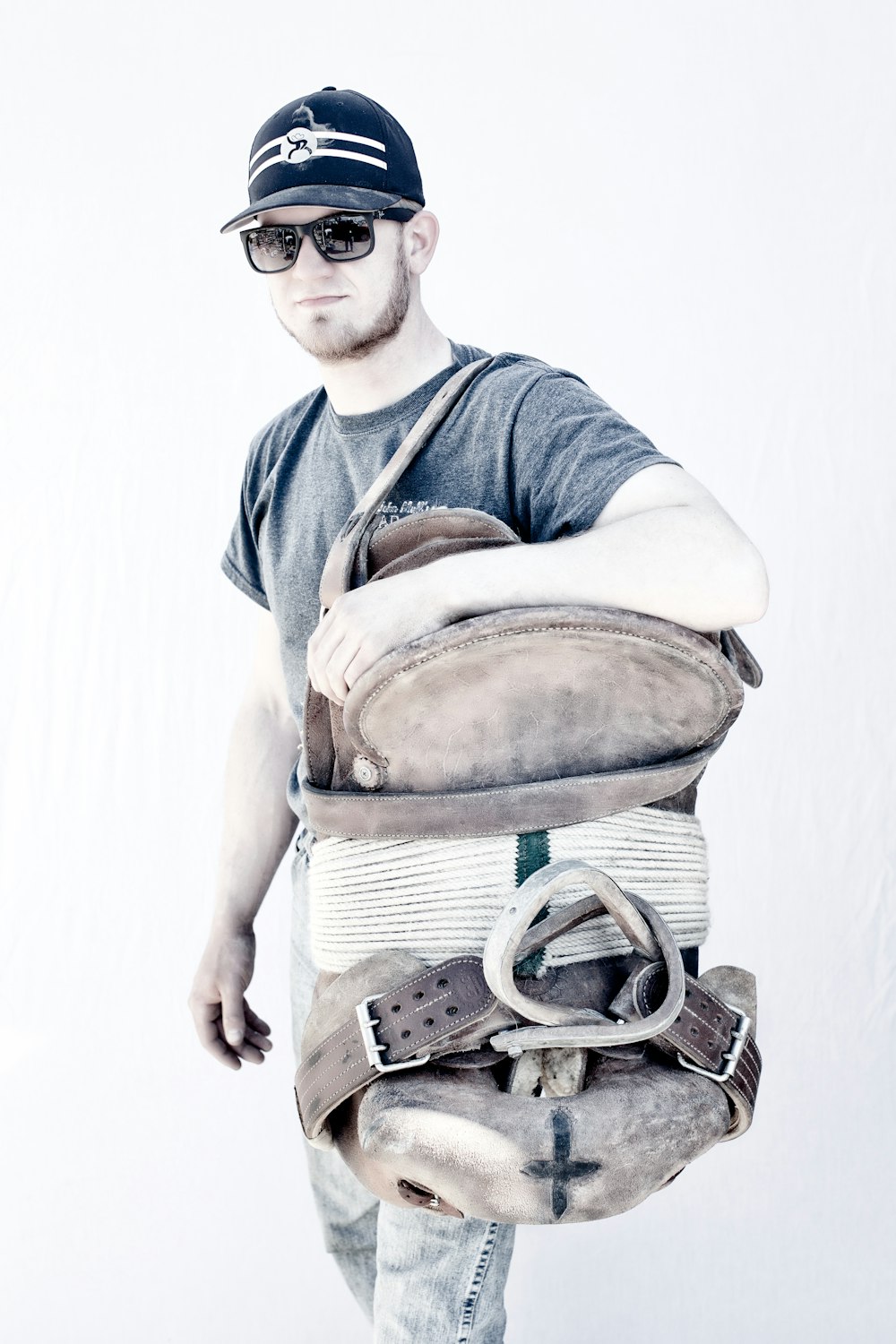 man in blue and white polo shirt carrying brown leather sling bag