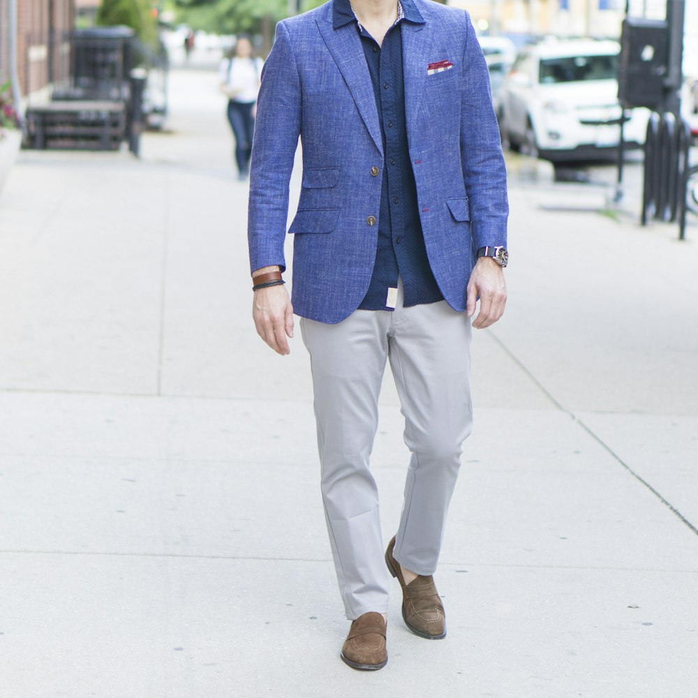 man in blue suit jacket and brown pants standing on sidewalk during daytime  photo – Free Usa Image on Unsplash