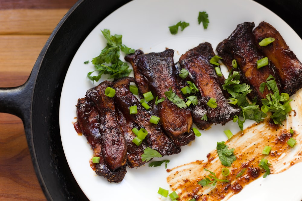 cooked meat with vegetable on white ceramic plate