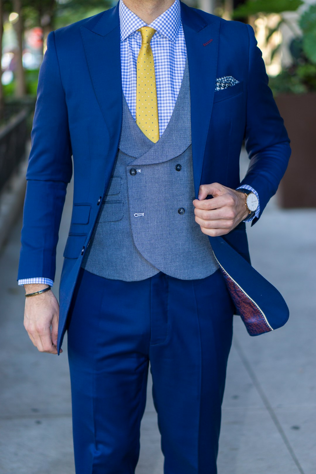 man in blue suit standing on road during daytime