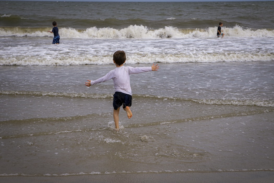 A boy running towards the beach