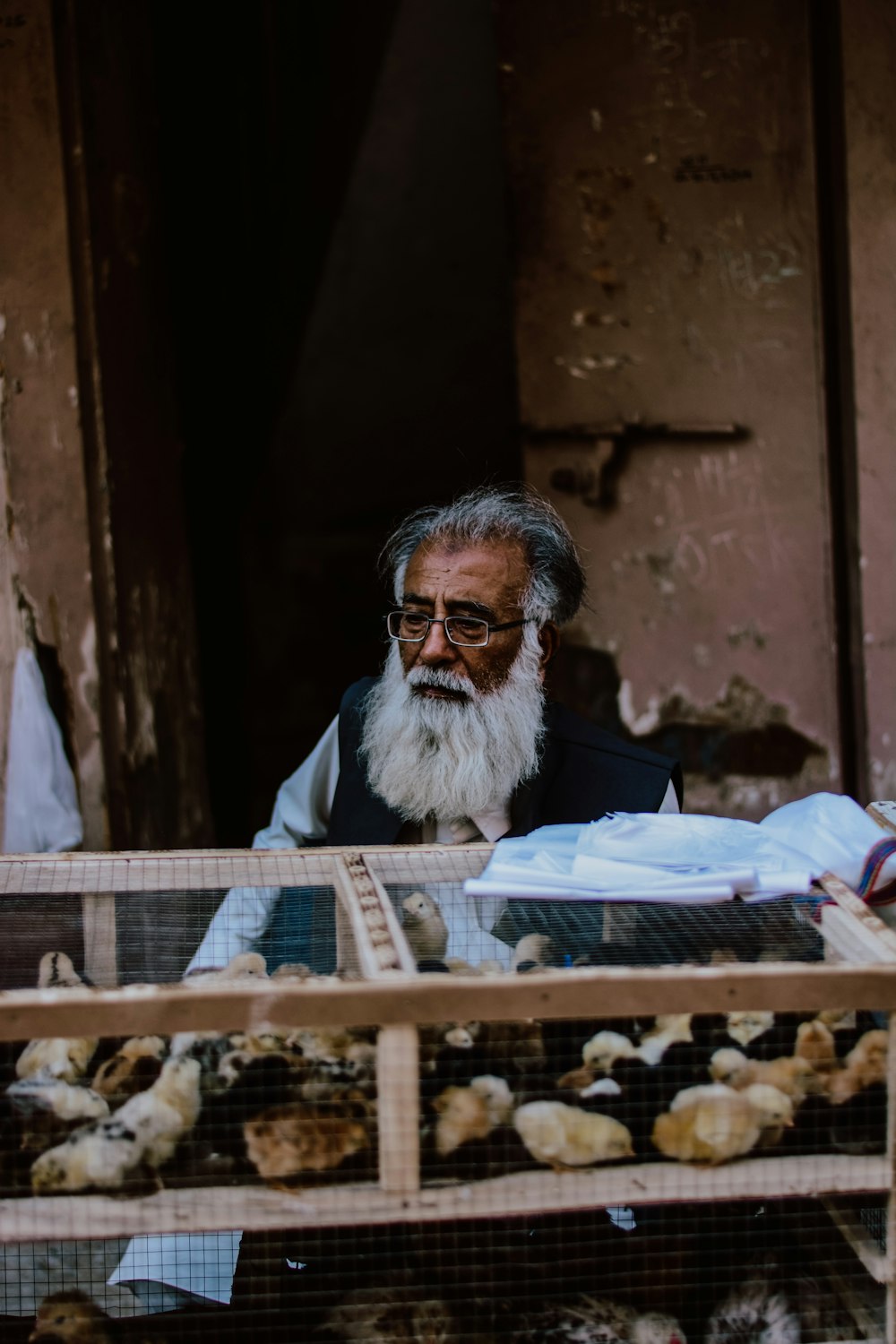 man in white and black scarf wearing black framed eyeglasses