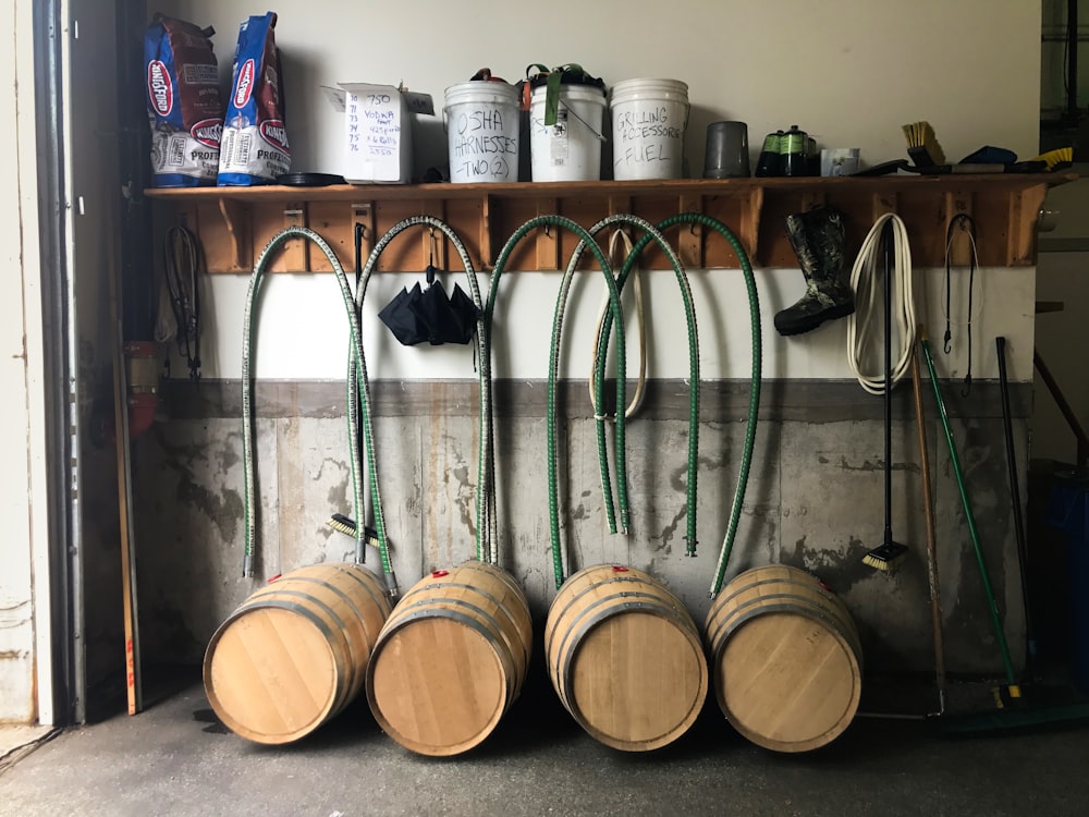 brown wooden barrels on black metal rack