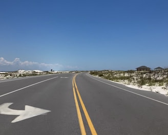 gray concrete road under blue sky during daytime