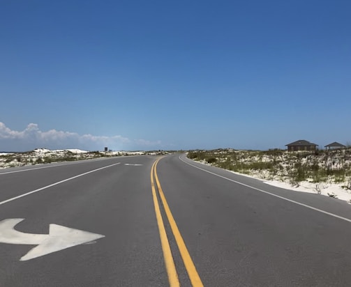 gray concrete road under blue sky during daytime