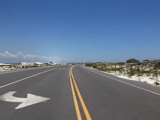 gray concrete road under blue sky during daytime