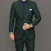 man in blue suit jacket and black pants