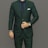 A well-dressed person is wearing a dark green suit paired with a navy blue shirt and matching tie. A white pocket square is tucked into the breast pocket. The person is adjusting the suit jacket with one hand, revealing a watch on the wrist.