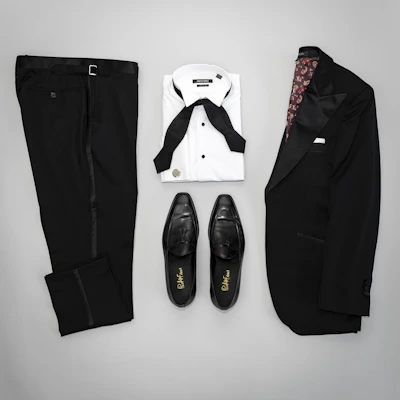 A stylish pair of men's trousers laid out neatly against a dark backdrop emphasizing their tailored fit.