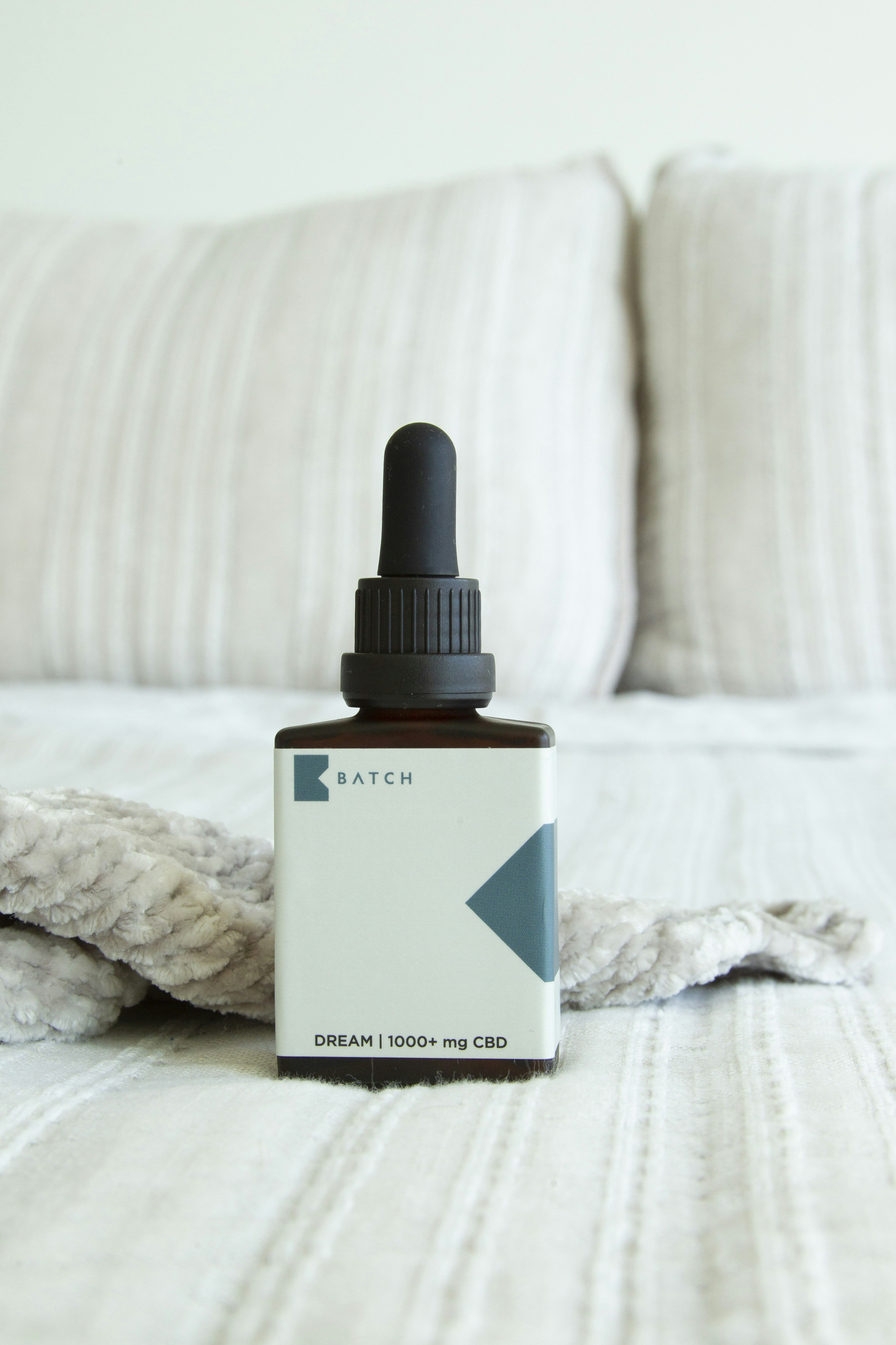 CBD oil tincture on bed