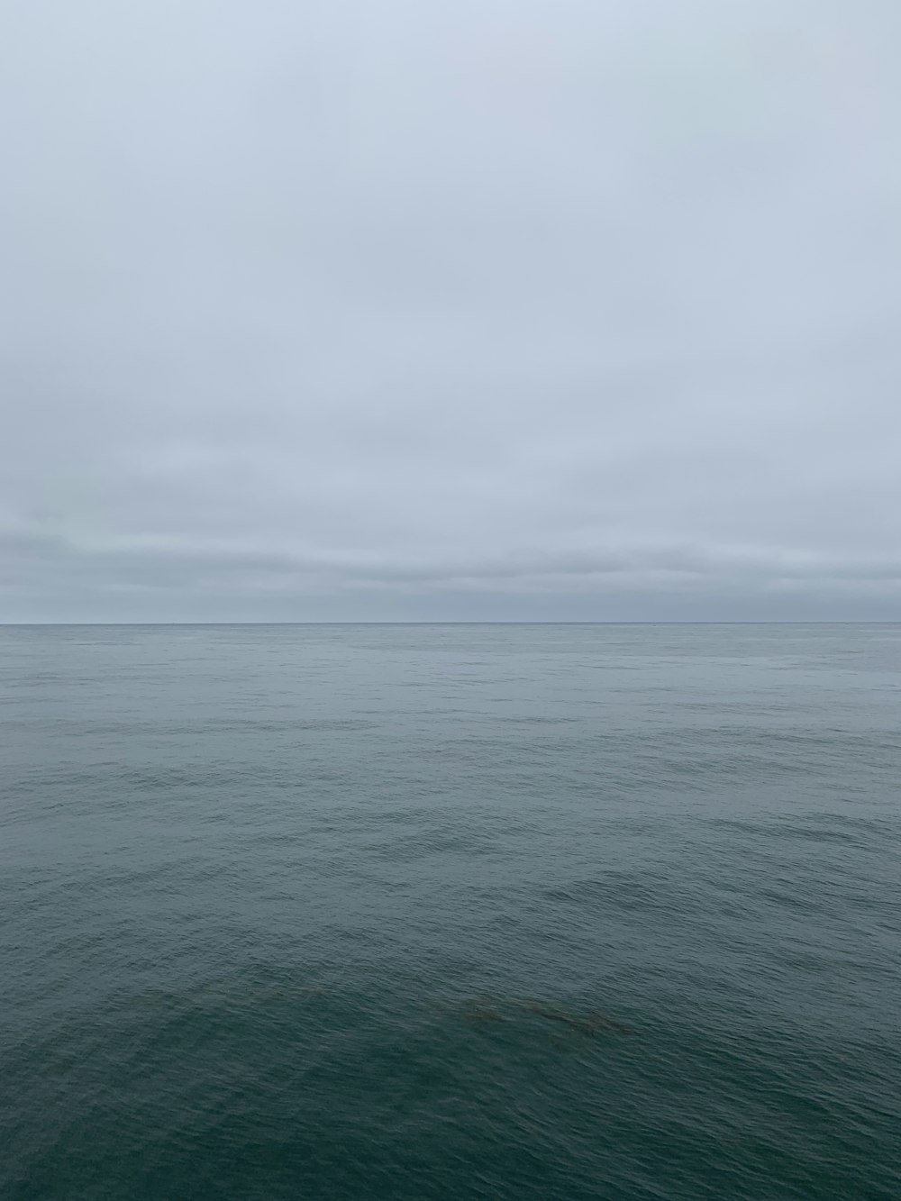 body of water under cloudy sky during daytime