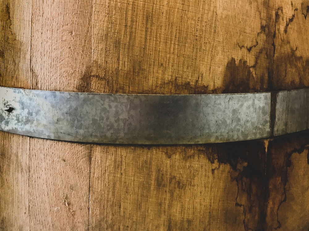 stainless steel round ornament on brown wooden surface