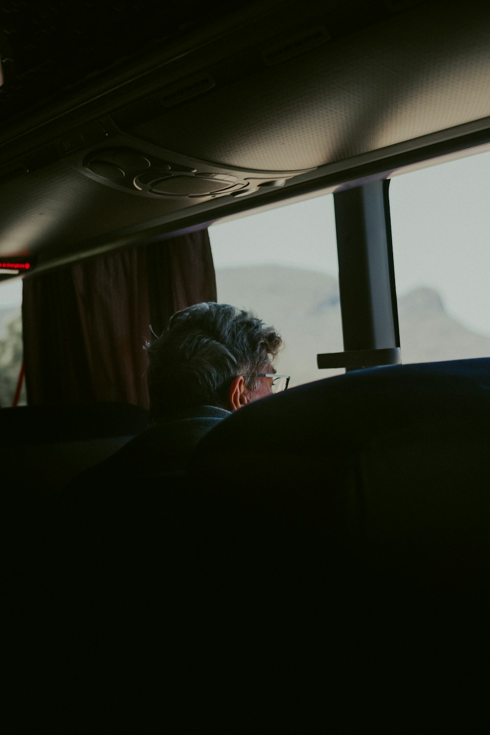 man in black shirt sitting on car seat