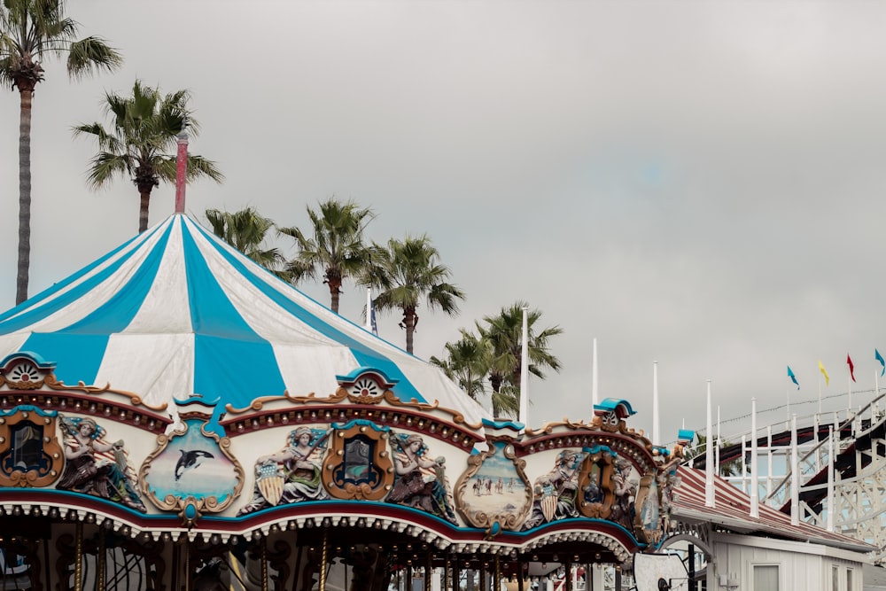 white and blue carousel under cloudy sky during daytime