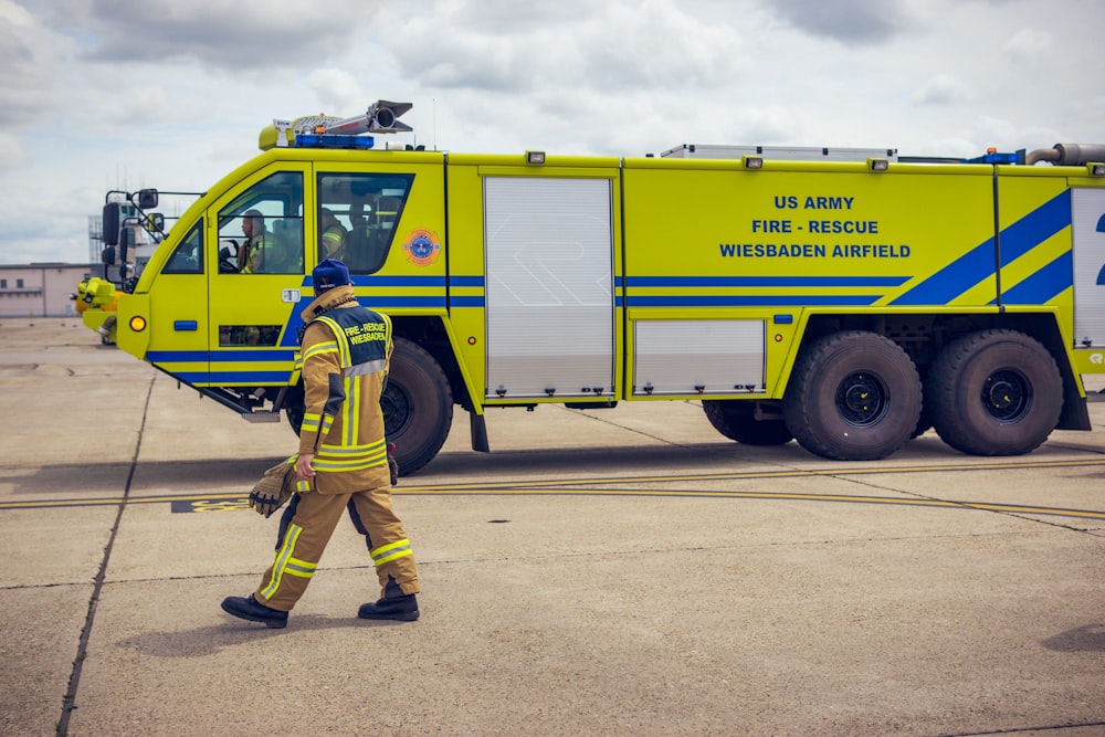 a fireman walking across an airport tarmac