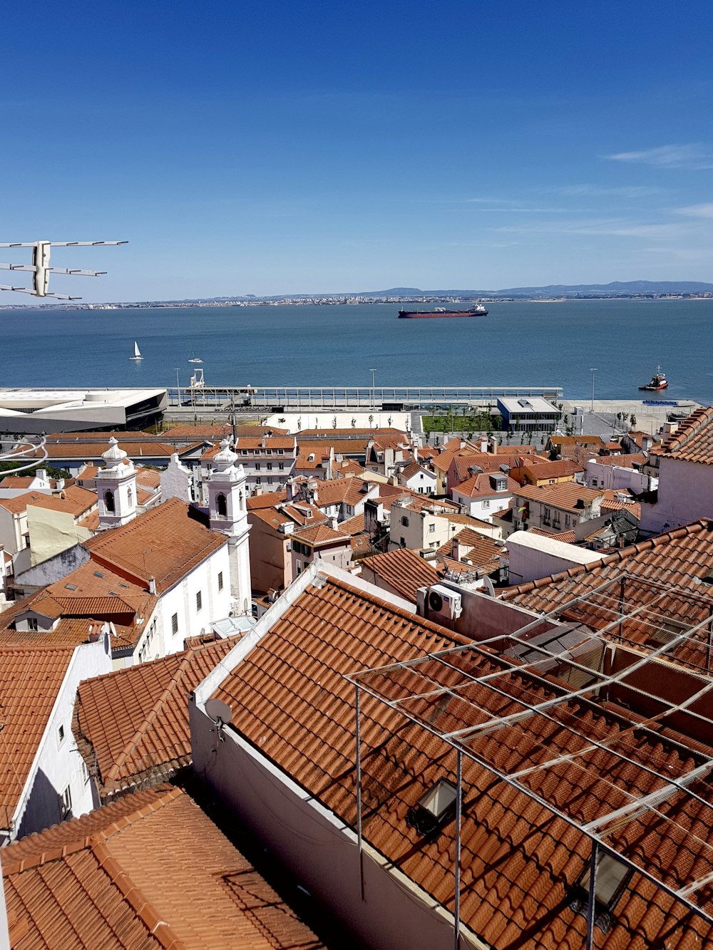 brown and white houses near sea during daytime