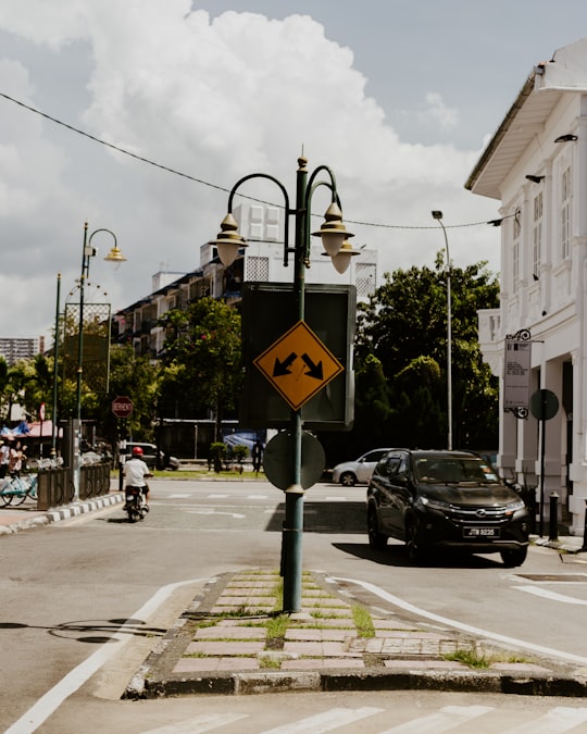 black car parked beside white building during daytime in Penang Island Malaysia