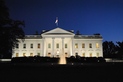 white concrete building during night time white house teams background