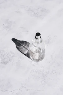 Elegant parfum mist bottle resting on a marble surface with natural light.
