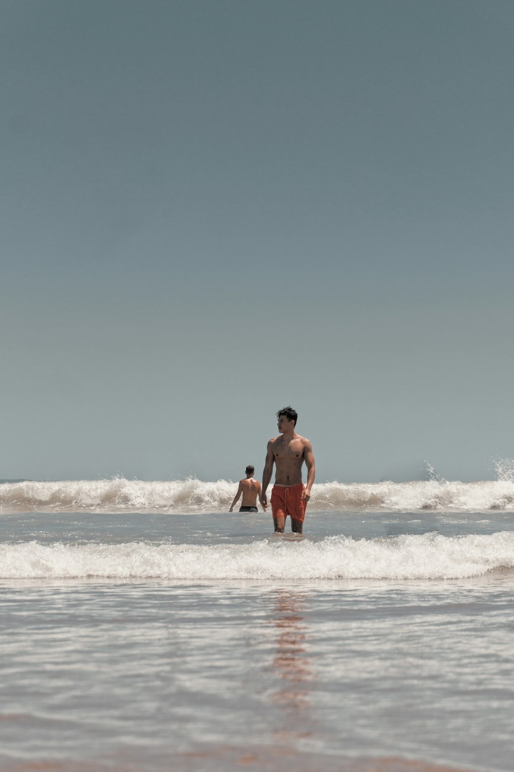 2 men in beach during daytime