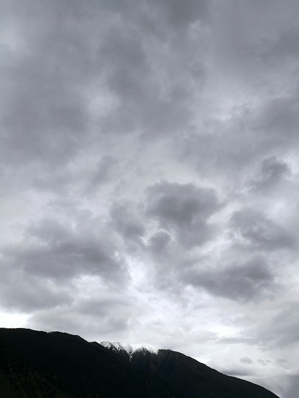 grayscale photo of clouds and mountain