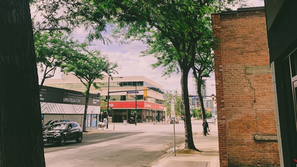 a city street with cars parked on the side of the road