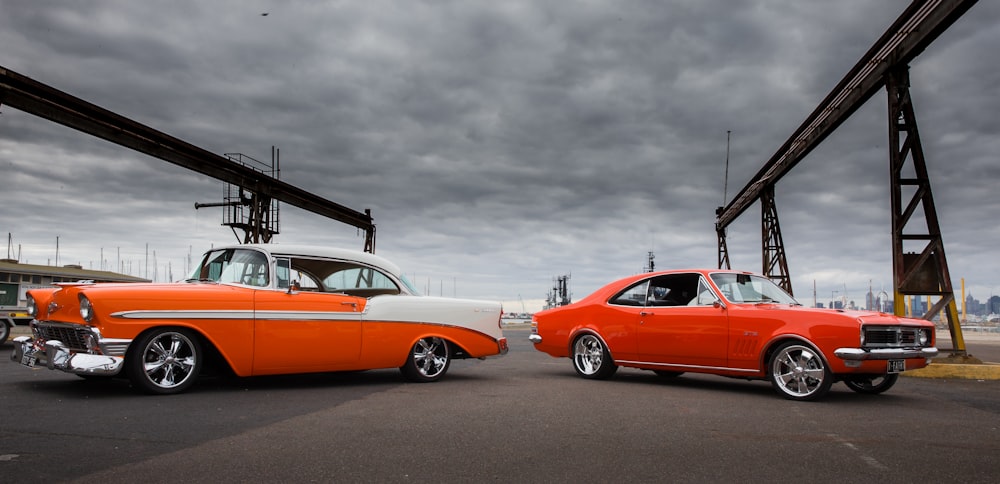 orange coupe on gray asphalt road under gray cloudy sky