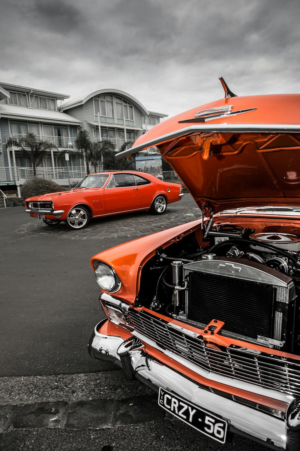 orange classic car on road during daytime