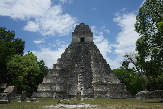 gray concrete building under blue sky during daytime in Tikal Guatemala