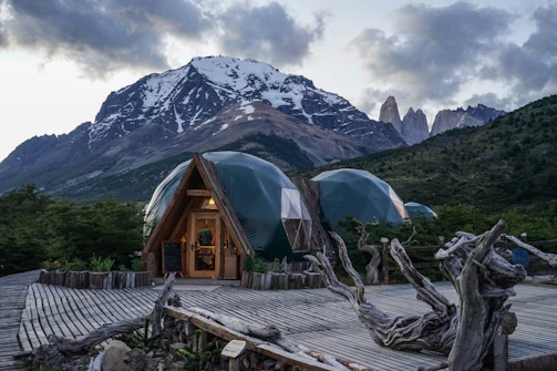brown wooden house near mountain during daytime