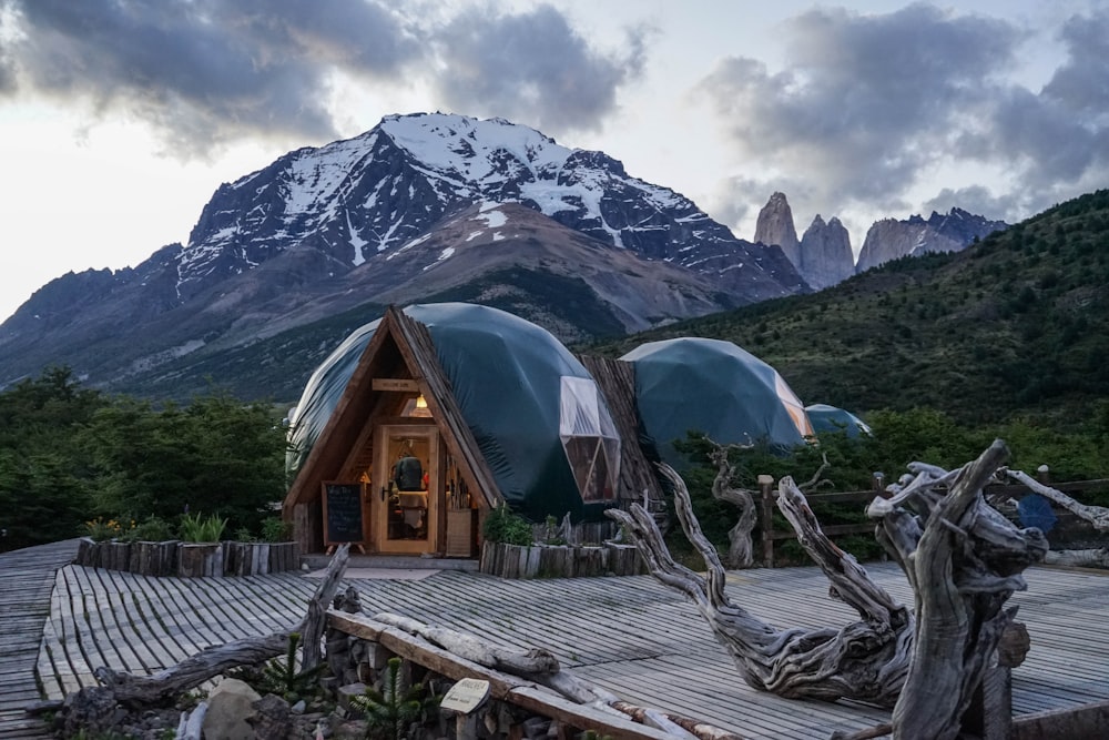 brown wooden house near mountain during daytime