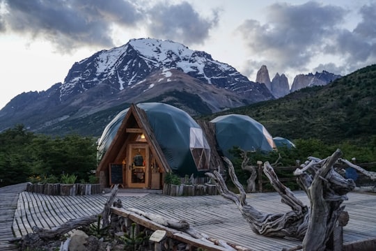brown wooden house near mountain during daytime in Torres del Paine National Park Chile