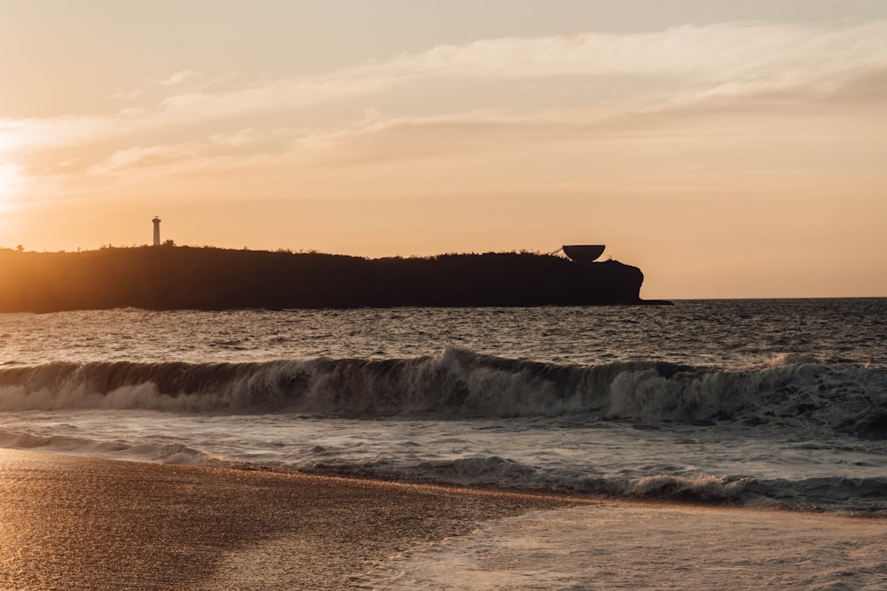 ocean waves crashing on shore during sunset