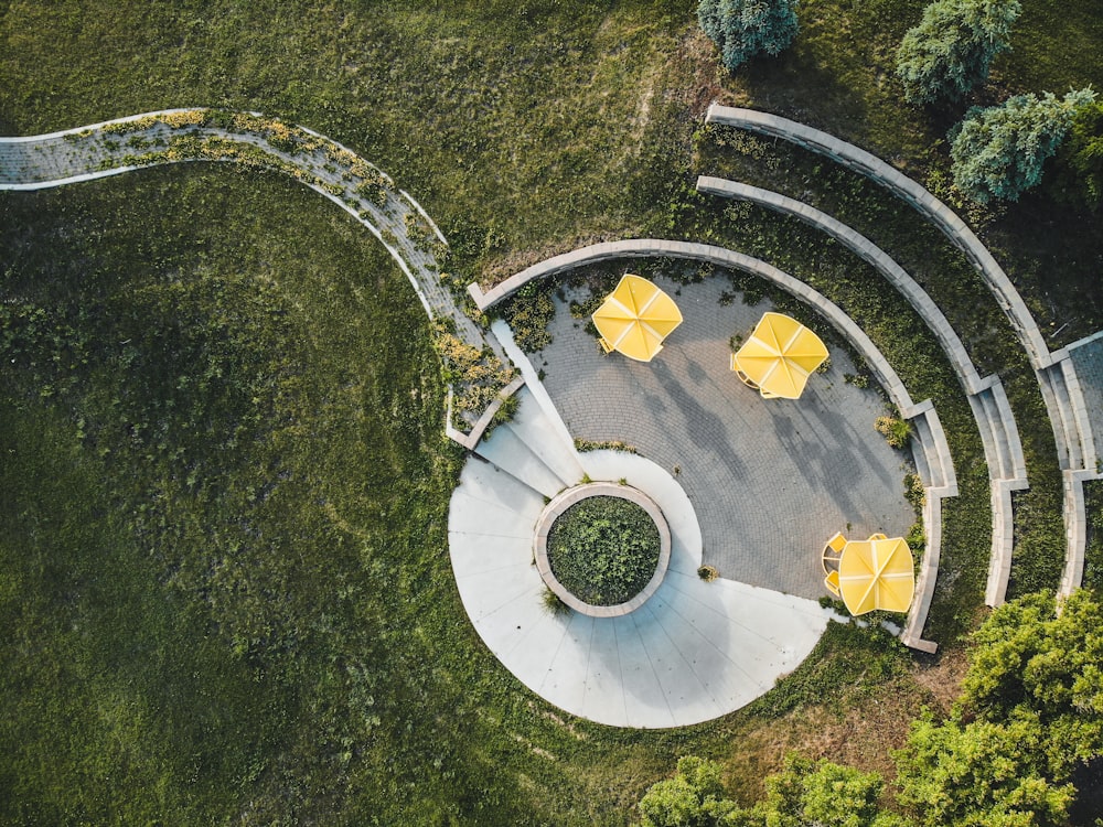 white concrete spiral stairs with yellow leaves on ground
