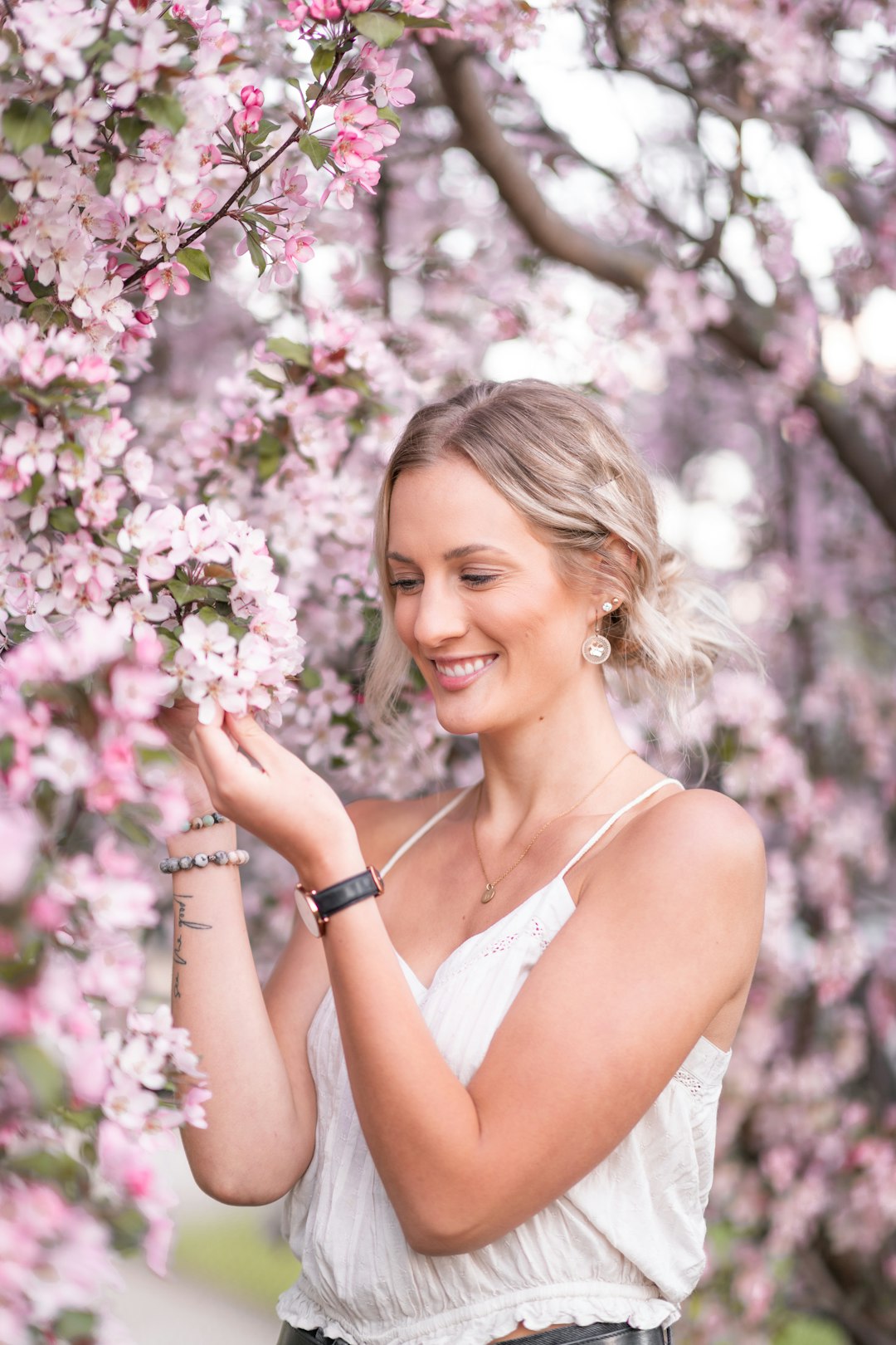 woman in white tank top smiling