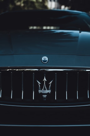 A close-up of a sleek car's front grille.