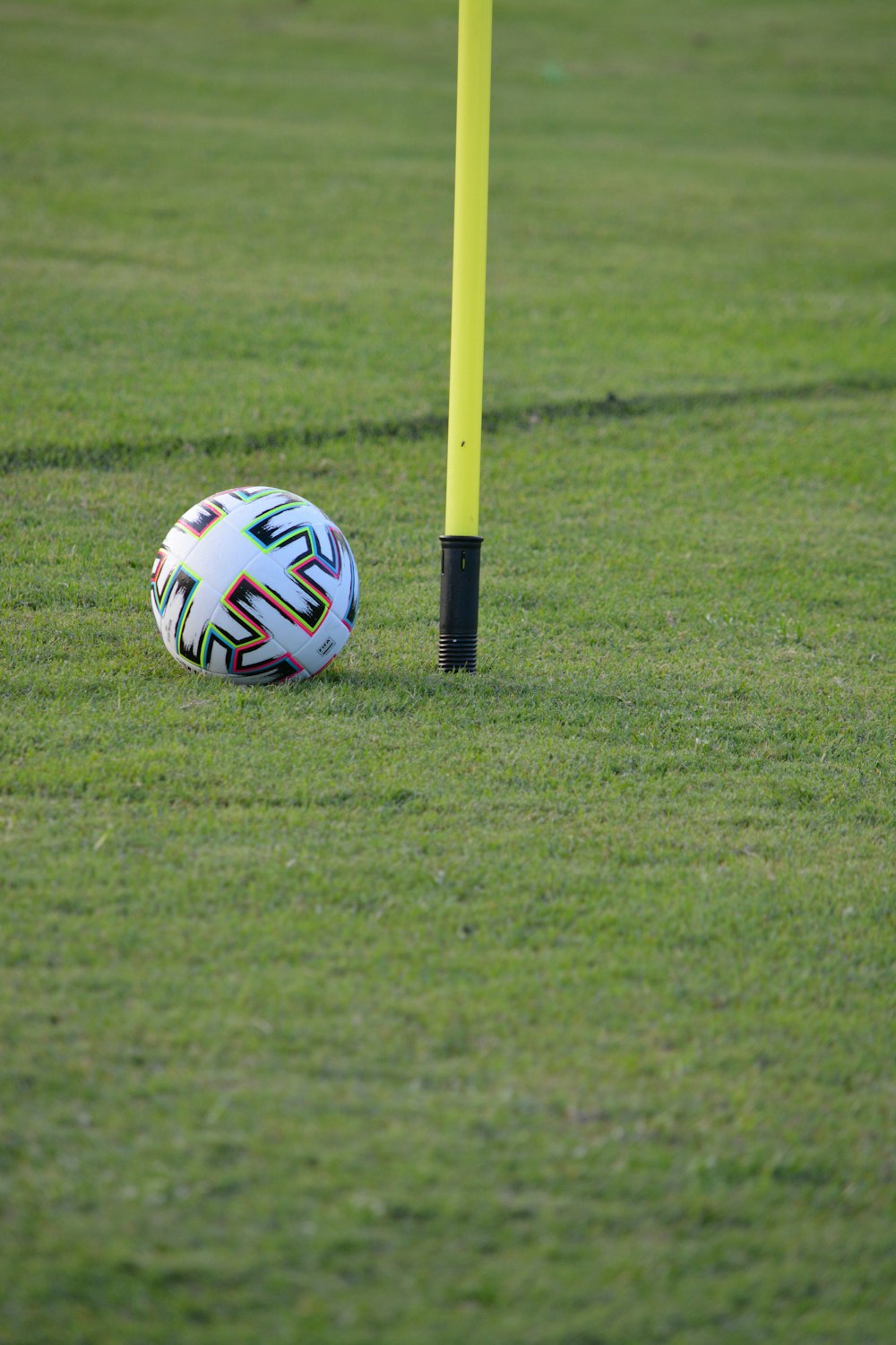 white blue and red soccer ball on green grass field