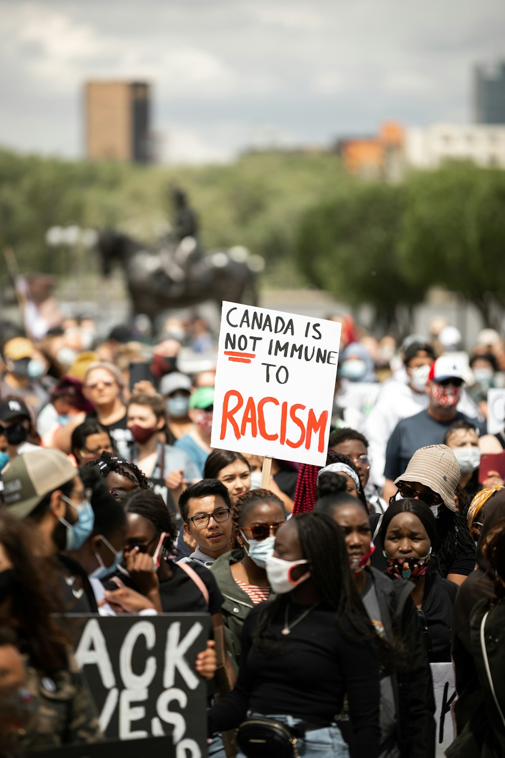 a large group of people holding signs in the street