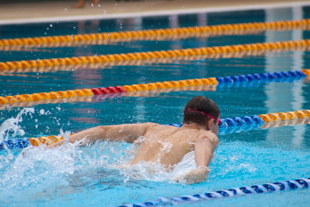 man in swimming pool during daytime