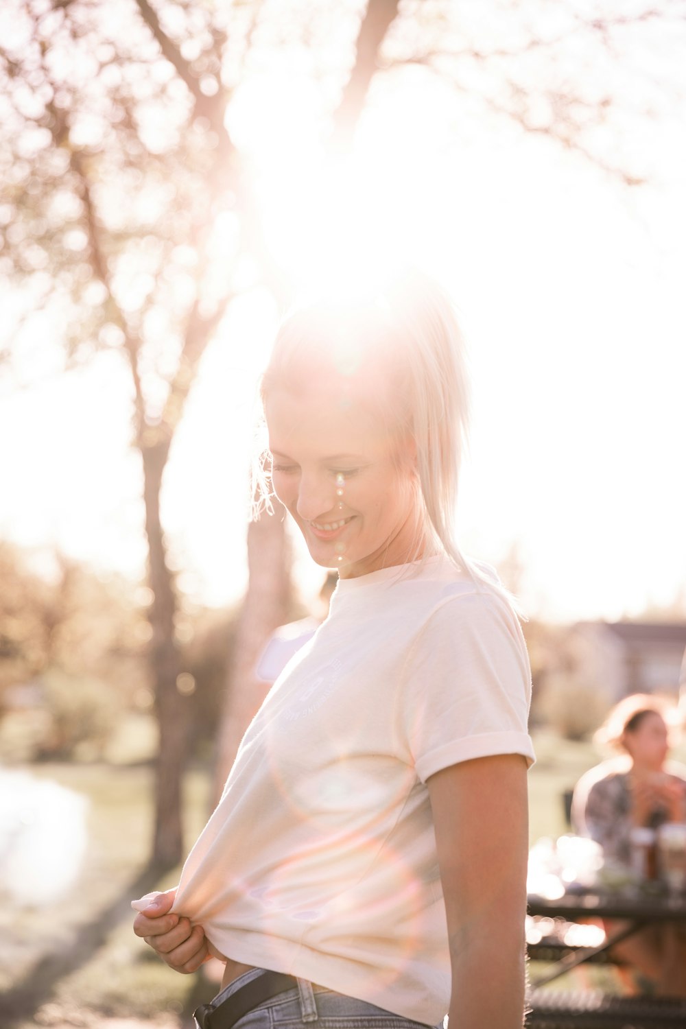 girl in white crew neck t-shirt standing during daytime