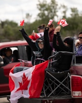 woman in black leather jacket sitting on gray shopping cart
