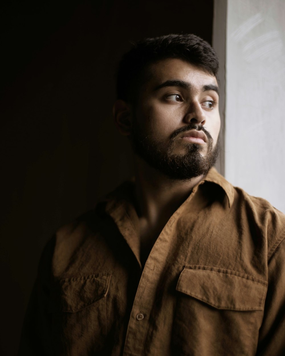 man in brown button up shirt