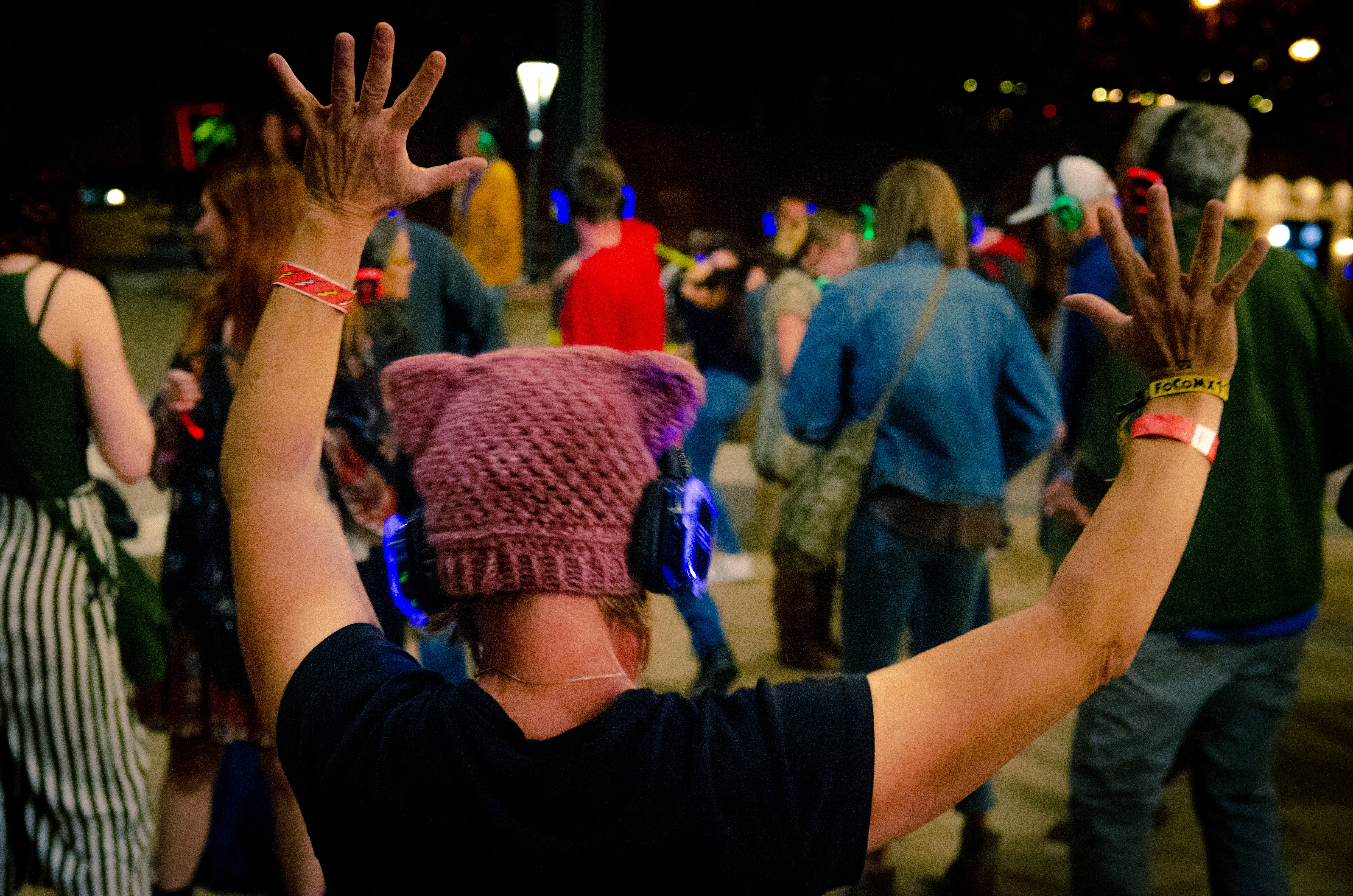 DJ Santos smiling with headphones around neck at outdoor event