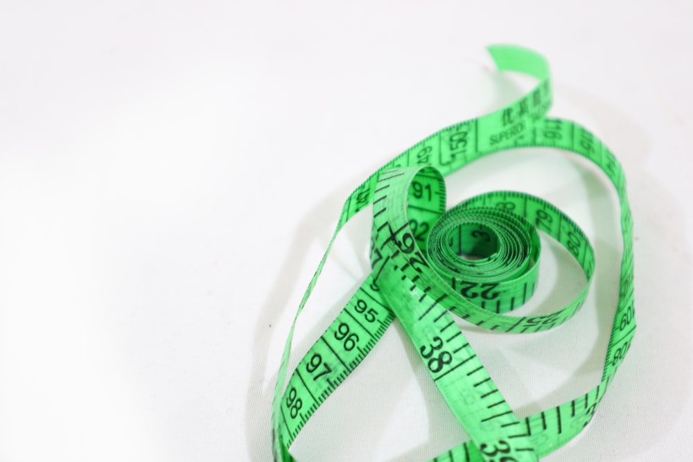 green and white ribbon on white surface